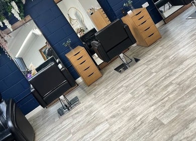 Modern salon chairs and mirrors at JD’s Beauty Bar, Pontyclun, Wales, GB, showcasing style and comfort.