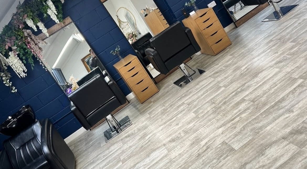 Modern salon chairs and mirrors at JD’s Beauty Bar, Pontyclun, Wales, GB, showcasing style and comfort.