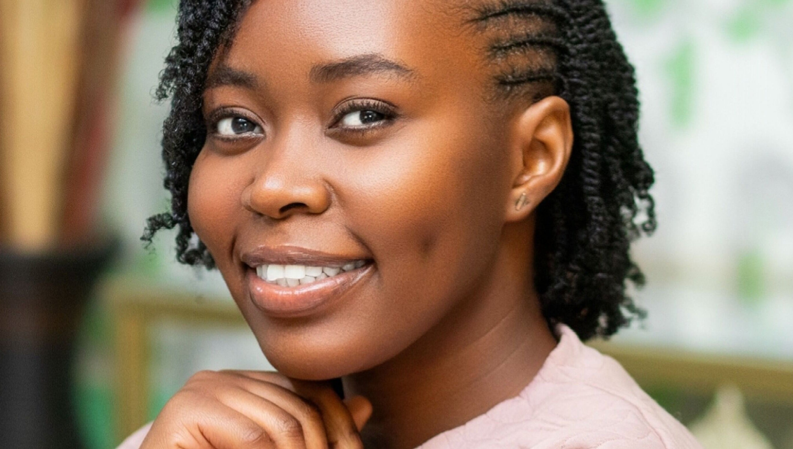 Woman smiling with styled hair at Natural Kurls Kabulonga Branch, Lusaka, Lusaka Province, ZM.