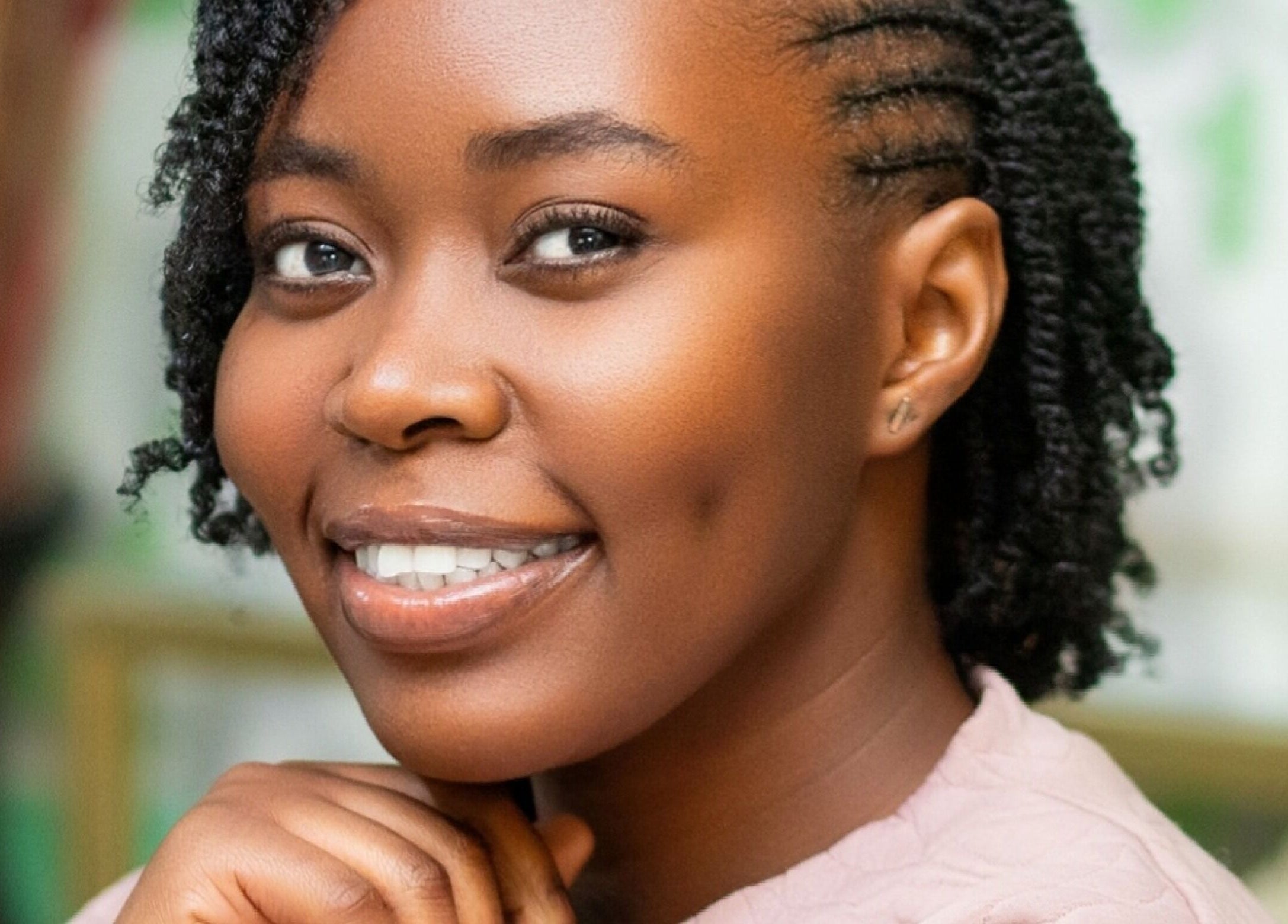 Woman smiling with styled hair at Natural Kurls Kabulonga Branch, Lusaka, Lusaka Province, ZM.
