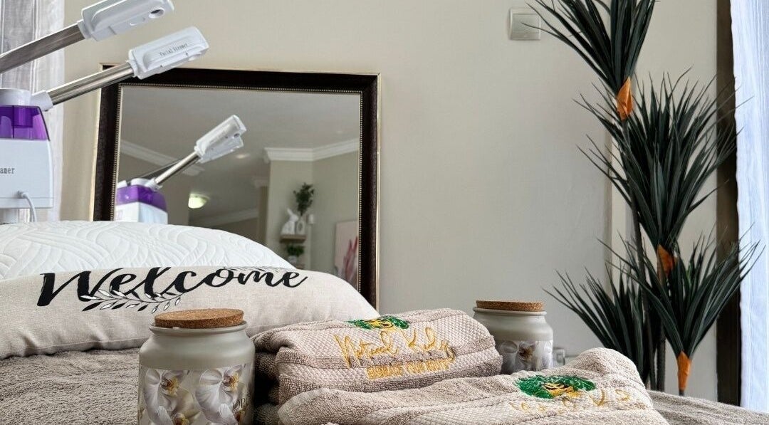 Relaxing treatment area at Natural Kurls Ndola Branch, Ndola, Copperbelt Province, ZM with plush towels and plants.