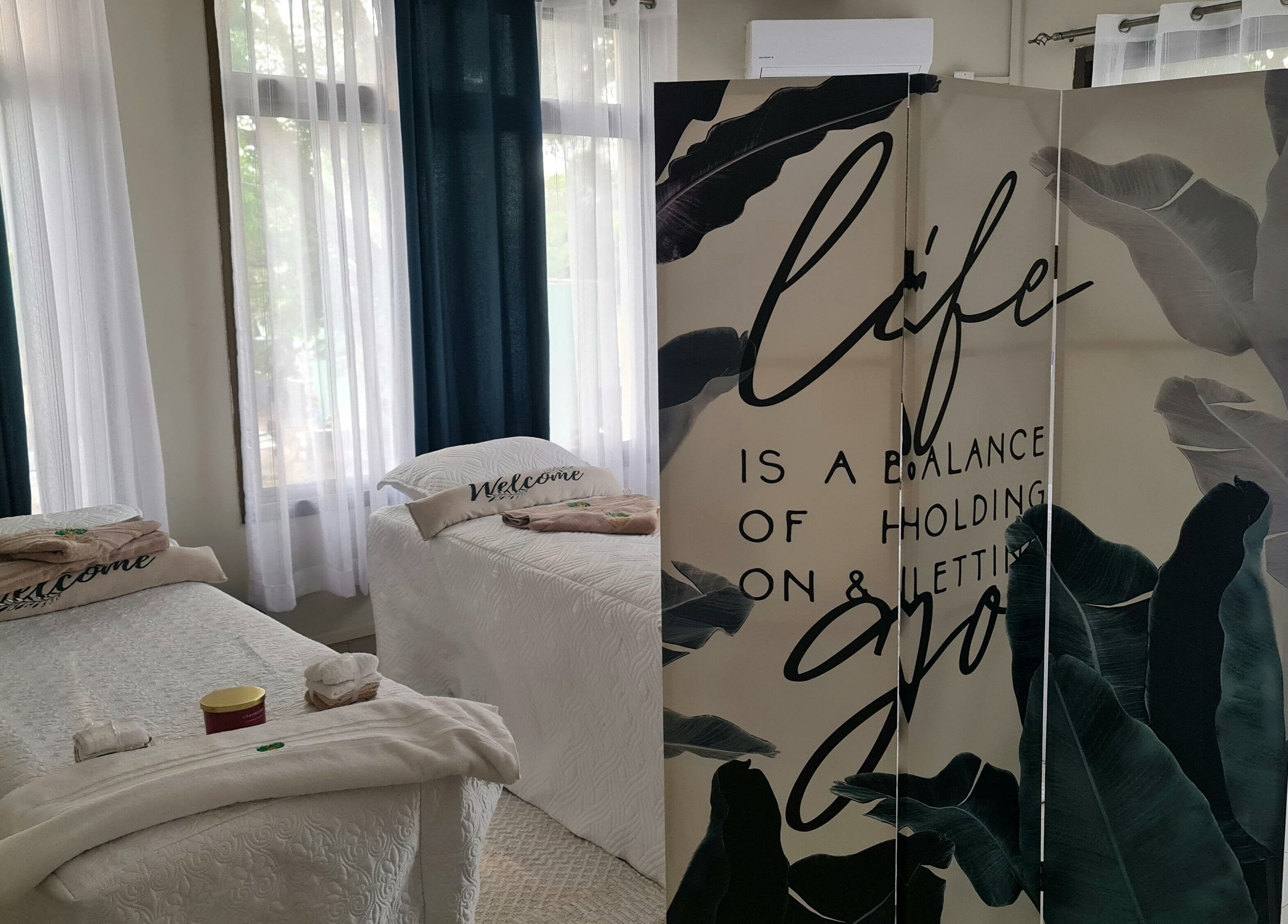 Relaxing treatment room at Natural Kurls Rhodespark Branch, Lusaka, ZM, with soothing decor and treatment beds.