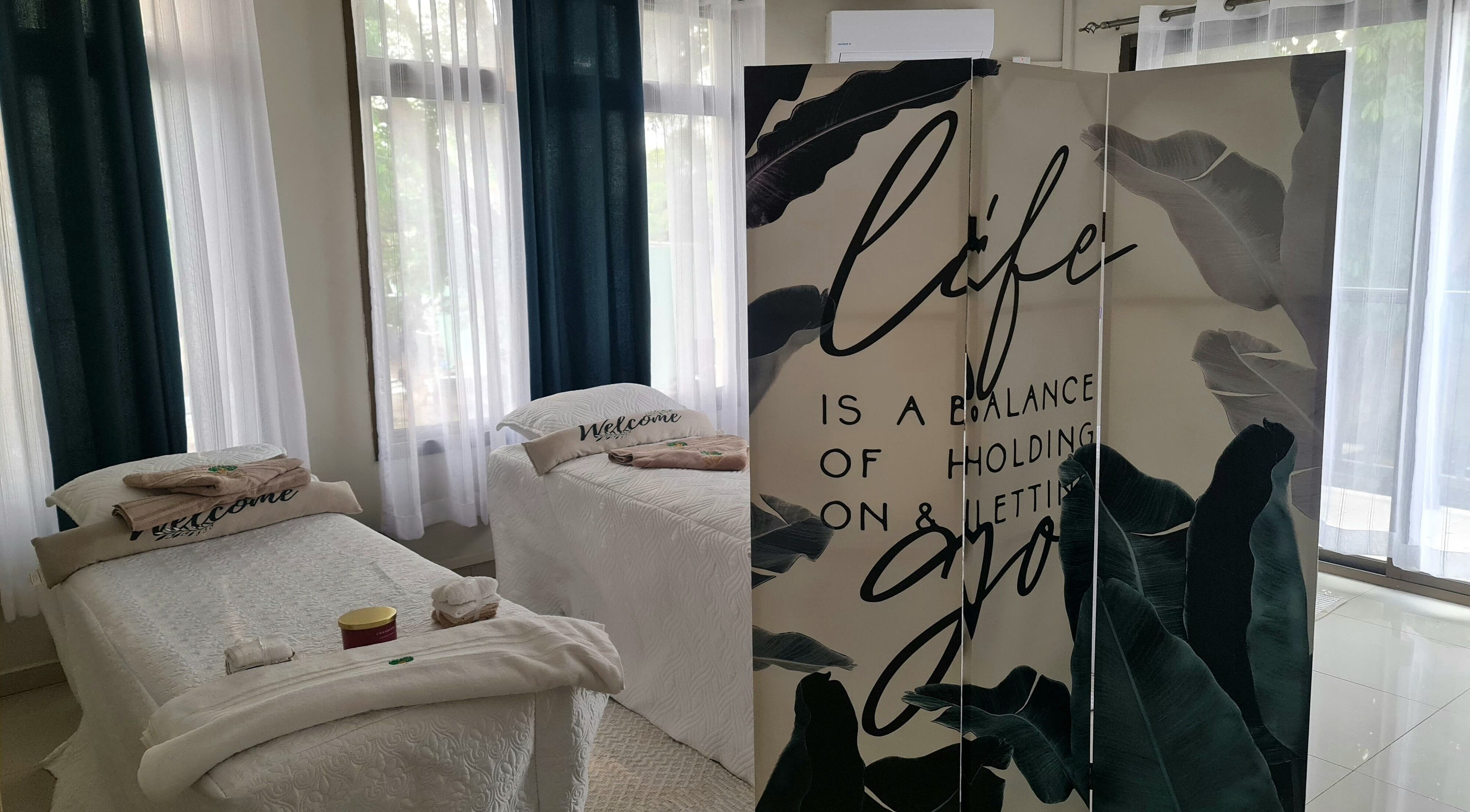 Relaxing treatment room at Natural Kurls Rhodespark Branch, Lusaka, ZM, with soothing decor and treatment beds.