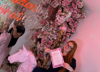 A vibrant, floral-themed corner at Time To Glow By Emily, Fleetwood, England, GB, with a unicorn sculpture.
