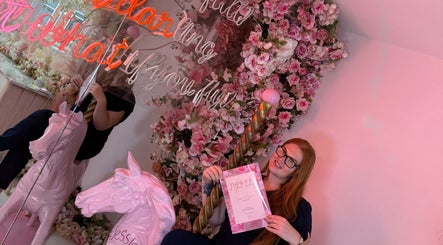 A vibrant, floral-themed corner at Time To Glow By Emily, Fleetwood, England, GB, with a unicorn sculpture.