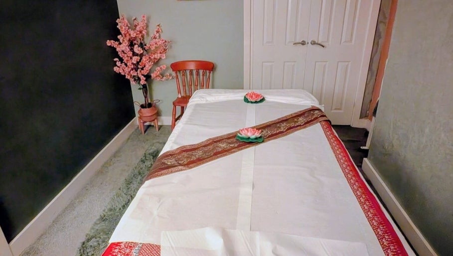 Tranquil massage room at Orchid Thai massage beauty and spa, Kidsgrove, England, GB, featuring a decorated table.