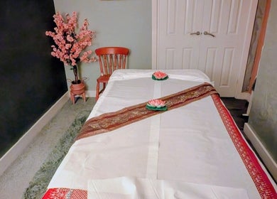 Tranquil massage room at Orchid Thai massage beauty and spa, Kidsgrove, England, GB, featuring a decorated table.