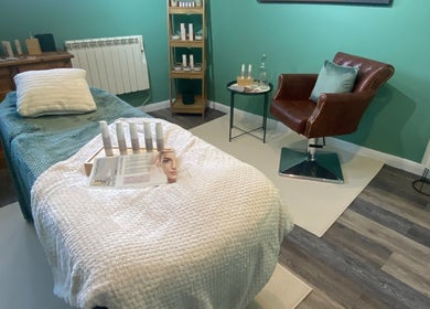 Relaxing treatment room at Urban Glow Beauty in Northam, England, GB, with plush bed and wellness products.
