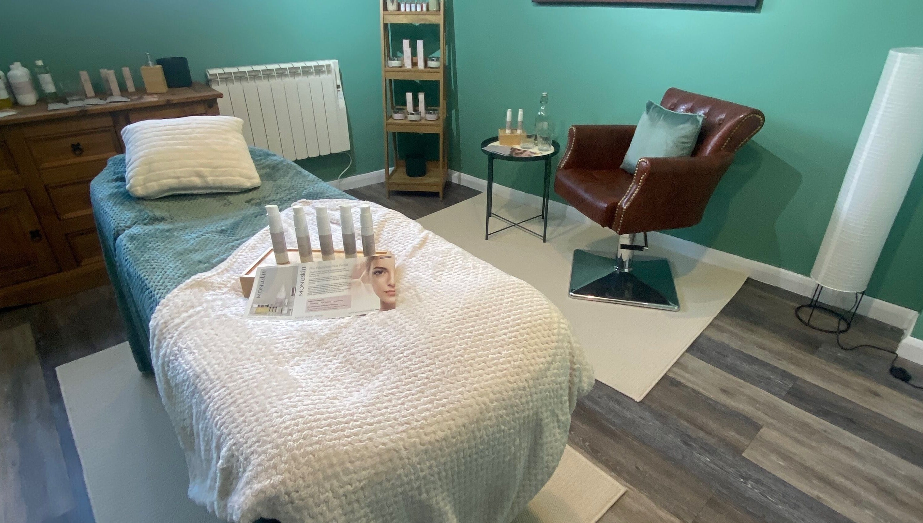 Cozy spa room at Urban Glow Beauty, Northam, England, GB. Features a treatment bed and skincare products.