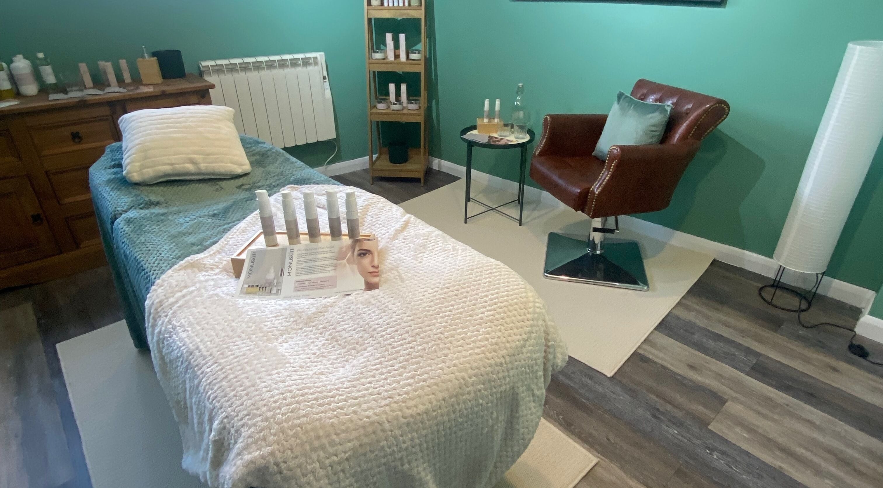 Cozy spa room at Urban Glow Beauty, Northam, England, GB. Features a treatment bed and skincare products.