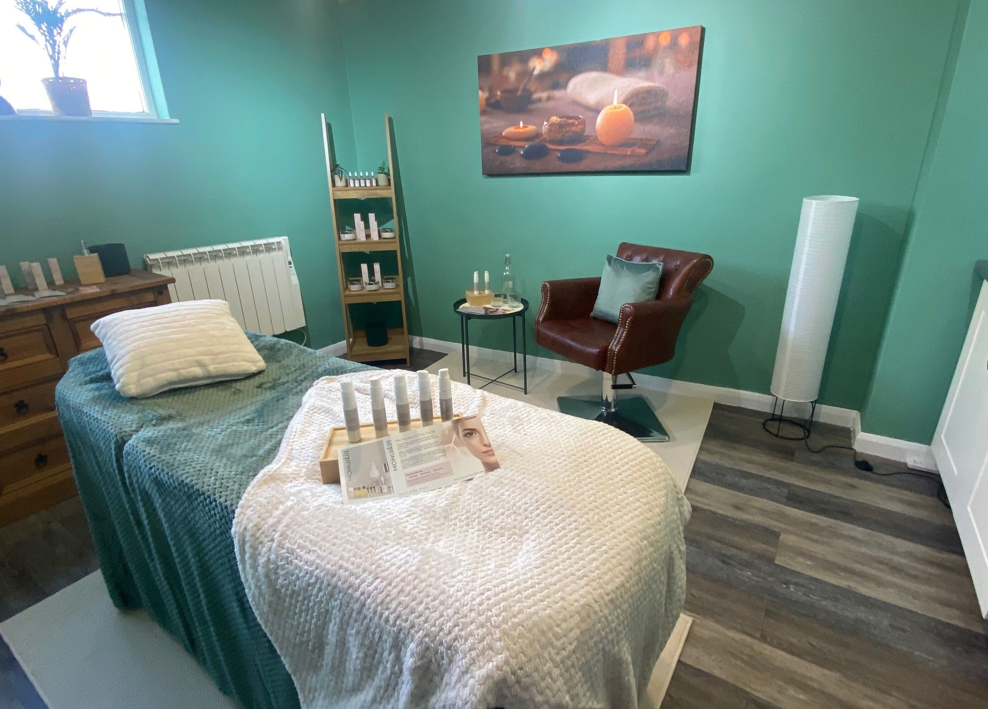 Spa room at Urban Glow Beauty, Northam, England with a massage bed and cozy decor.