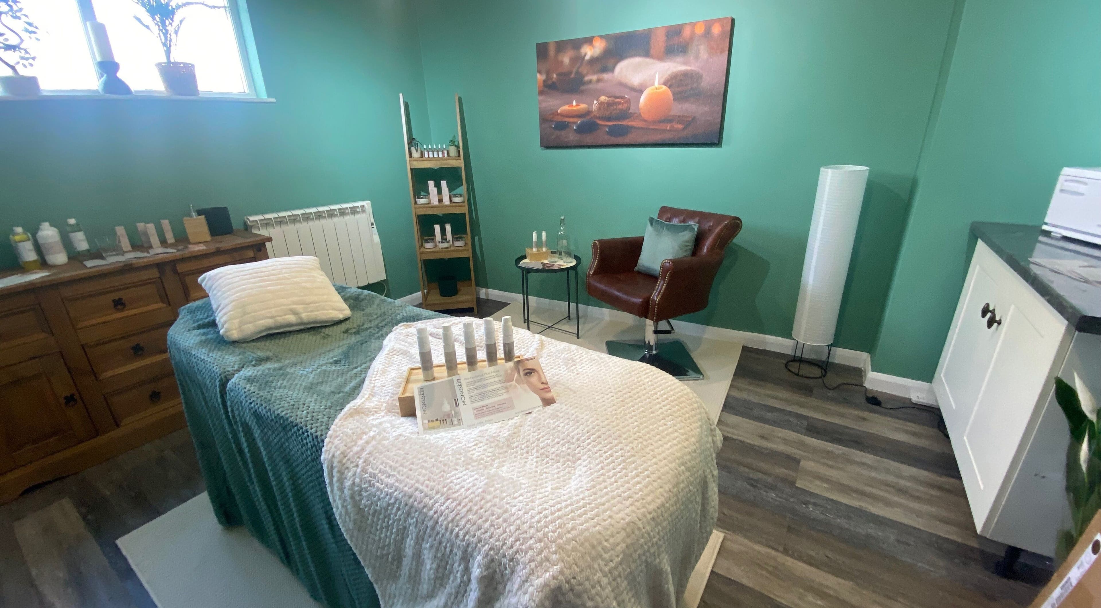 Spa room at Urban Glow Beauty, Northam, England with a massage bed and cozy decor.