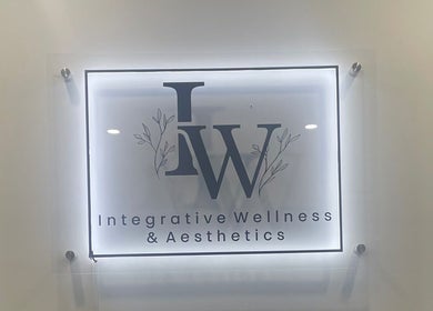 Illuminated sign of Integrative Wellness & Aesthetics in Laredo, Texas, US, showcasing sleek modern design.