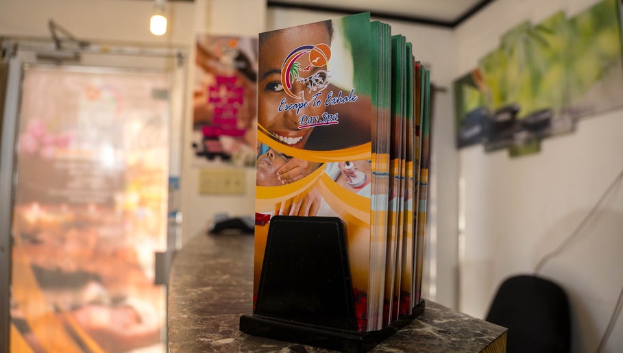 Escape To Exhale Day Spa brochures on display at St. James Parish, St. James Parish, JM reception desk.