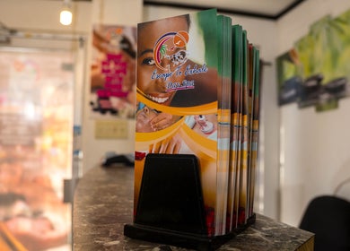 Escape To Exhale Day Spa brochures on display at St. James Parish, St. James Parish, JM reception desk.