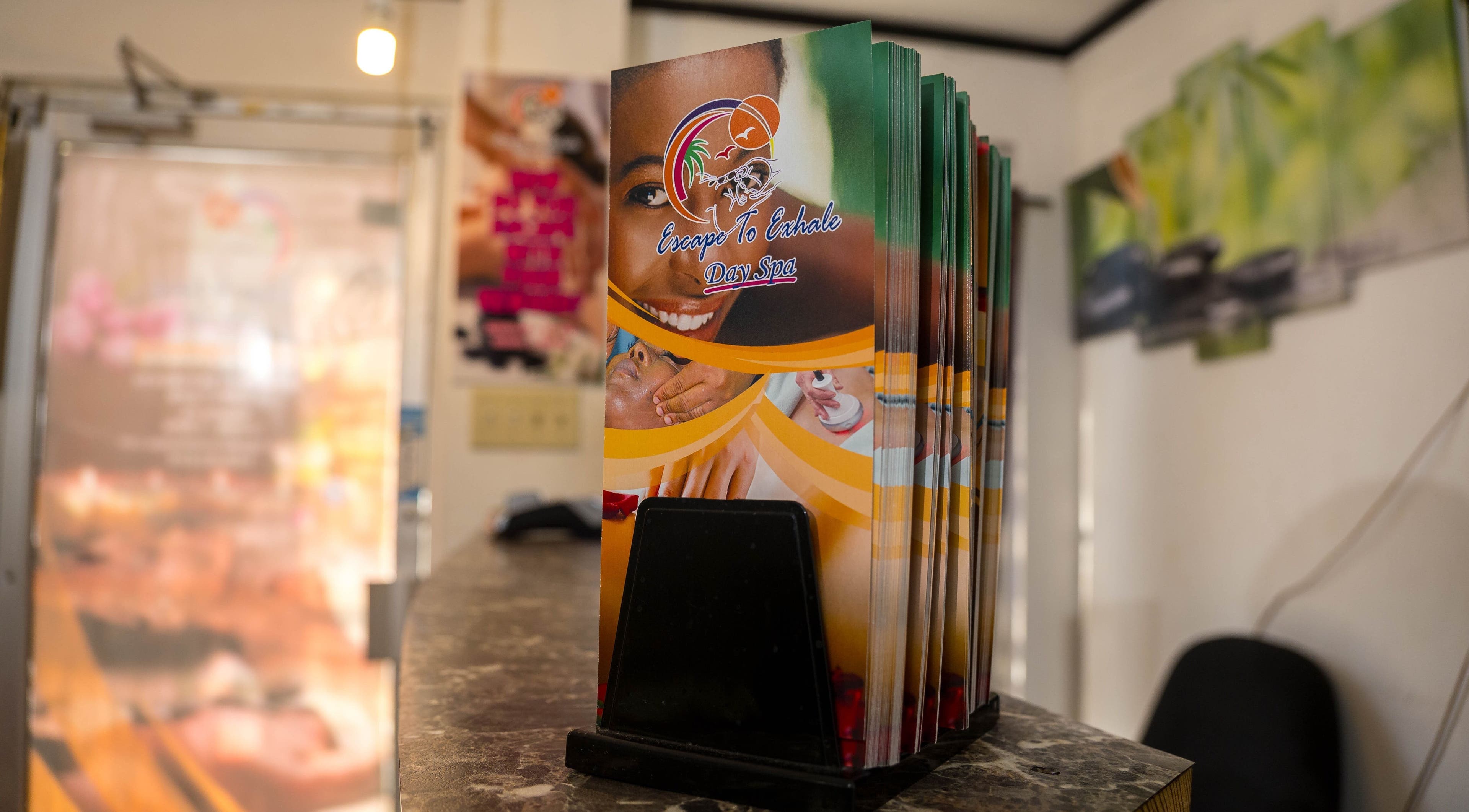 Escape To Exhale Day Spa brochures on display at St. James Parish, St. James Parish, JM reception desk.