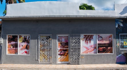 Front view of Escape To Exhale Day Spa at St. James Parish, showcasing beauty services with vivid window displays.