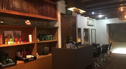 Elegant interior of Su-a hair studio, Singapore, SG with stylish chairs and product display.
