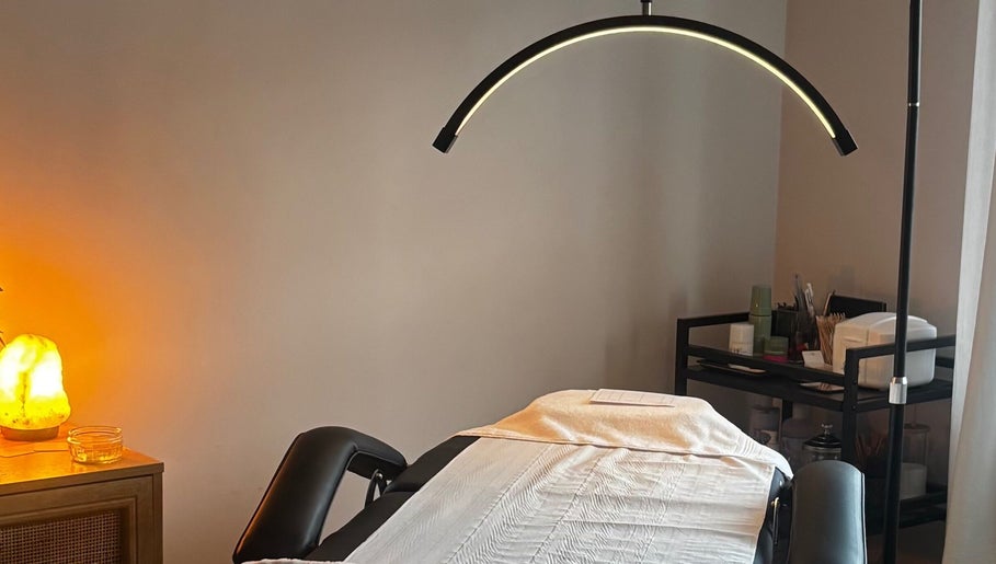 Serene treatment room at Formè, Evesham, England, GB, featuring a massage table with ambient lighting.