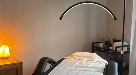 Serene treatment room at Formè, Evesham, England, GB, featuring a massage table with ambient lighting.