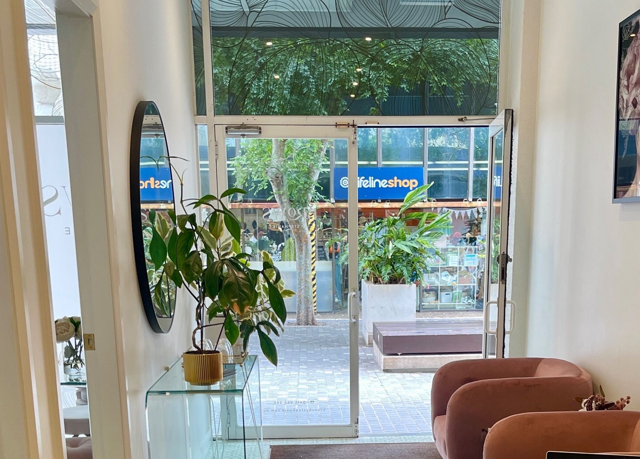 Entrance to Sydney Lashess by Nicky in Manly, New South Wales, AU, showcasing stylish interior and lush plants.