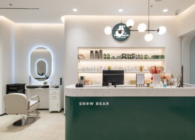 Reception area at Snow Bear Warringah Mall, Brookvale, New South Wales, AU showcasing sleek design and beauty products.