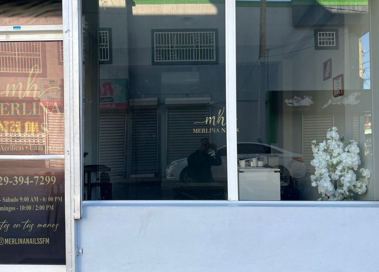 Fachada de Merlina Nails en San Francisco De Macorís, Duarte, DO, con decoración floral y horario visible.
