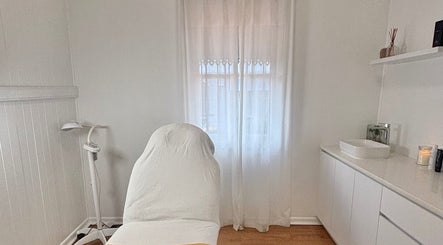 Tranquil treatment room at The Glow Up Clinic, Kangaroo Point, Queensland, AU with massage table and calm decor.