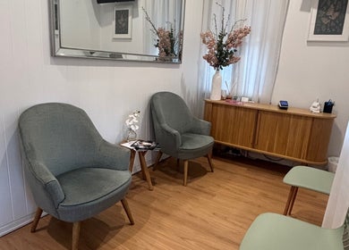 The Glow Up Clinic (Brisbane) waiting area in Kangaroo Point, Queensland, AU with chairs and elegant decor.