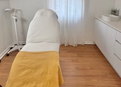 Serene treatment room at The GLOW UP Clinic (Brisbane), Kangaroo Point, Queensland, AU with cozy setup.
