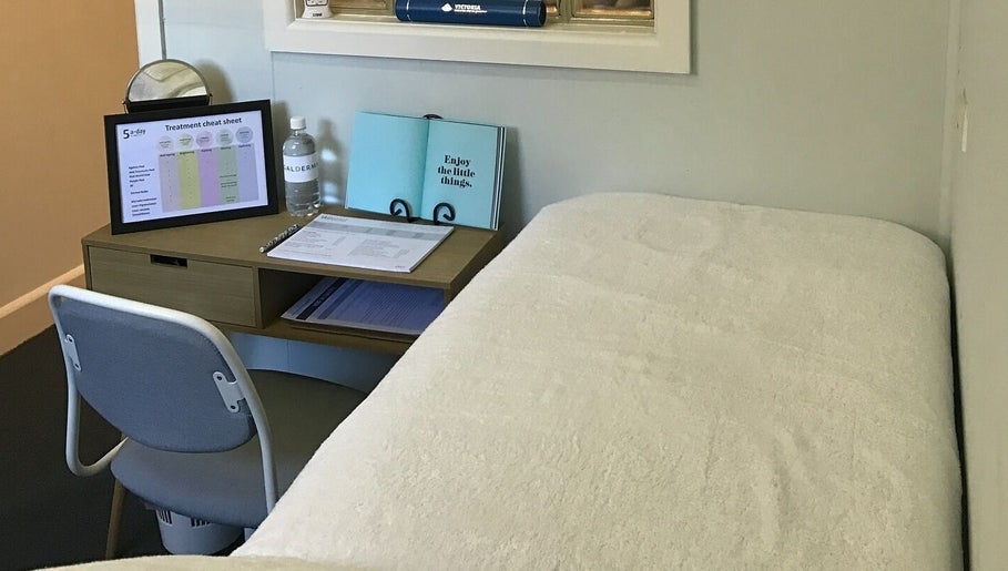 Cozy treatment room at The GLOW UP Clinic (Brisbane) in Kangaroo Point, Queensland, AU with a comfortable chair and desk.