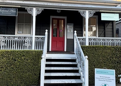 The GLOW UP Clinic (Brisbane) at Kangaroo Point, Queensland, AU features a quaint facade with intricate white railings.