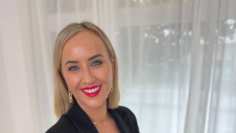 Smiling person at The GLOW UP Clinic (Elsternwick), Melbourne, Victoria, AU with elegant decor.