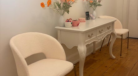 Chic seating area at The GLOW UP Clinic (Elsternwick), Melbourne, Victoria, AU with plush chairs and floral decor.
