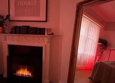 Cozy room at The GLOW UP Clinic (Elsternwick), Melbourne, Victoria, AU with decorative fireplace and warm ambiance.