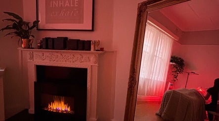 Cozy room at The GLOW UP Clinic (Elsternwick), Melbourne, Victoria, AU with decorative fireplace and warm ambiance.
