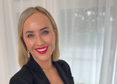 Smiling individual at The GLOW UP Clinic in Albert Park, Melbourne, Victoria, AU with bright red lipstick.
