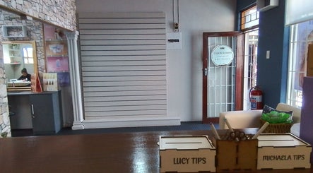 Reception of Lucy Hairstylist @ Cape & Scissors, Mossel Bay, Western Cape, ZA with stylish decor and entry door.