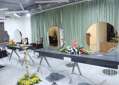 Sophisticated salon interior at Shaakya Spa & Wellness, Bengaluru, Karnataka, IN, showcasing styling stations.