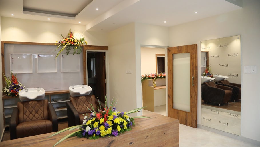 Elegant interior at Shaakya Spa & Wellness, Bengaluru, Karnataka, IN with luxurious seating and vibrant floral décor.