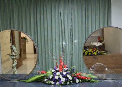 Elegant floral display between round mirrors at Shaakya Spa & Wellness, Bengaluru, Karnataka, IN.