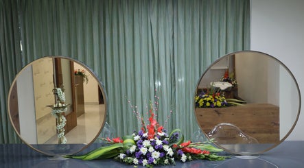 Elegant floral display between round mirrors at Shaakya Spa & Wellness, Bengaluru, Karnataka, IN.