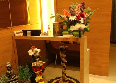Reception area at Shaakya Spa & Wellness, Bengaluru, Karnataka, IN with flowers and decor.