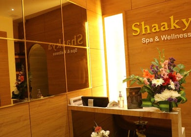 Reception area of Shaakya Spa & Wellness, Bengaluru, Karnataka, IN, with vibrant floral arrangement.