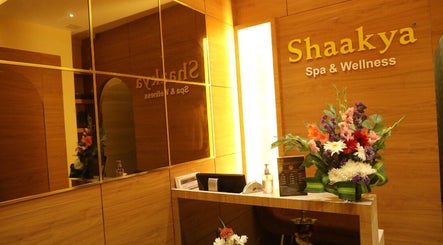 Reception area of Shaakya Spa & Wellness, Bengaluru, Karnataka, IN, with vibrant floral arrangement.