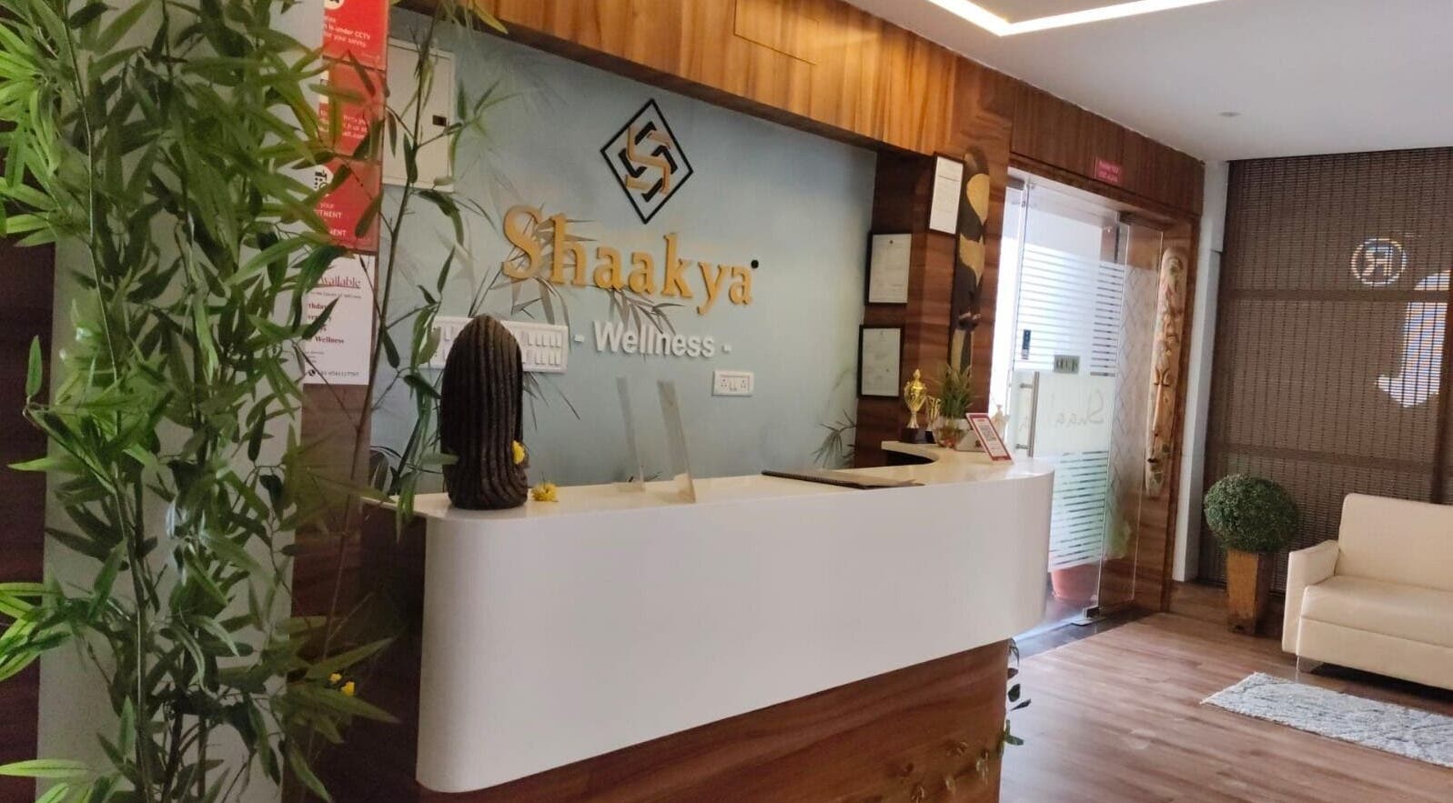 Reception area of Shaakya Spa & Wellness, Bengaluru, Karnataka, IN with plants and modern decor.