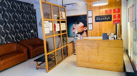 Reception area of Shaakya Spa & Salon, Bengaluru, Karnataka, IN. Stylish design with leather sofas and modern decor.