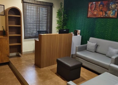 Reception at Shaakya Spa & Wellness in Bengaluru, Karnataka, IN. Cozy ambiance with modern decor and Buddha art.