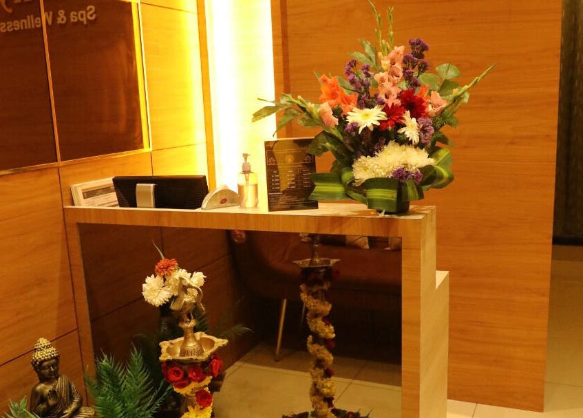 Reception area at Shaakya Spa & Wellness, Bengaluru, Karnataka, IN with vibrant floral decor.