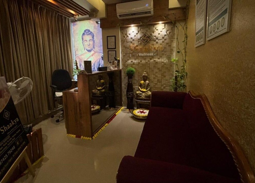 Reception area at Shaakya Spa & Wellness, Bengaluru, Karnataka, IN, featuring serene Buddha decor.